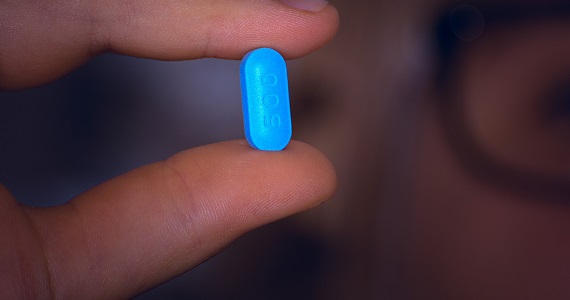 person holding PrEP oral medication